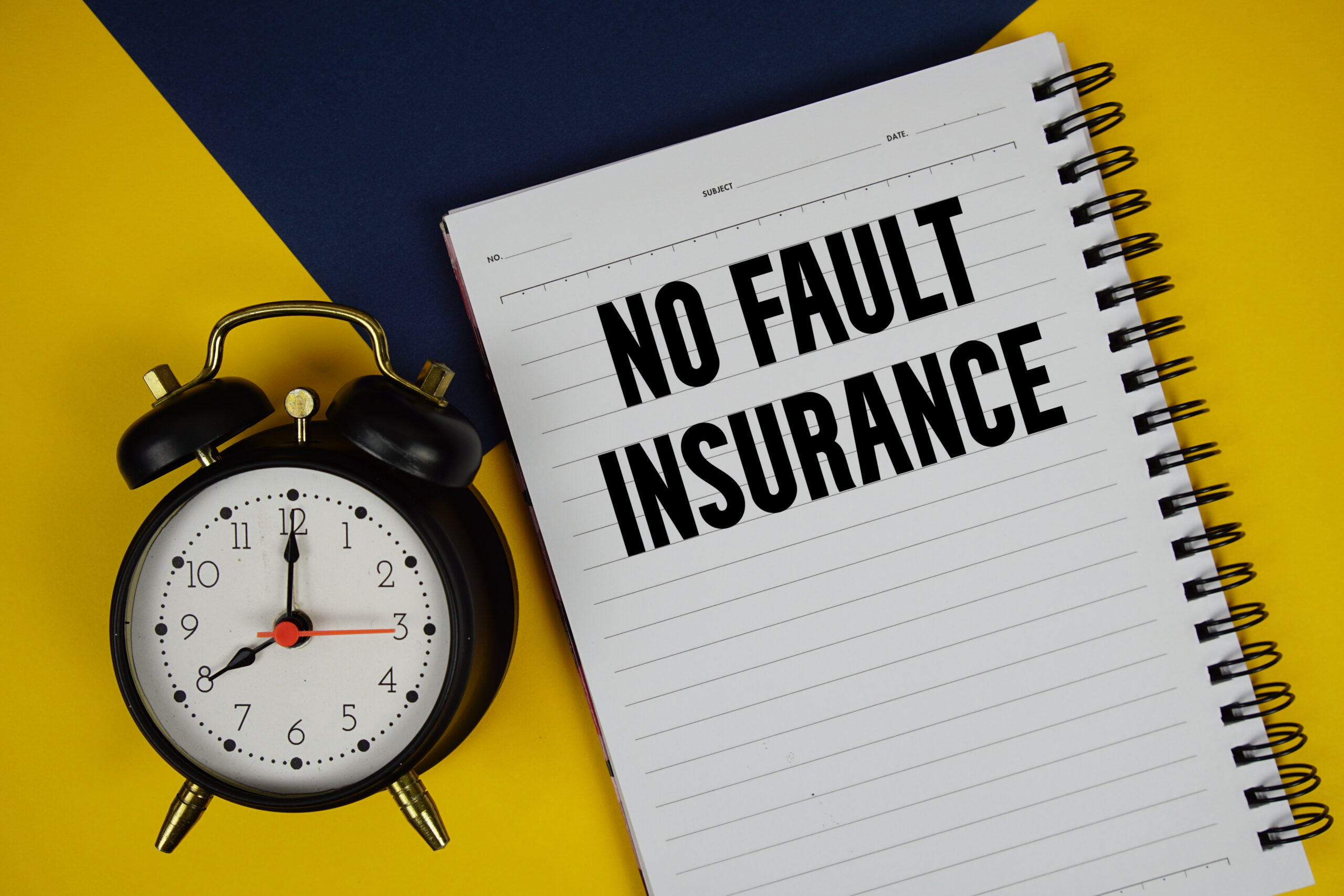 No Fault Insurance text written on notepad with alarm clock on yellow background no fault insurance form